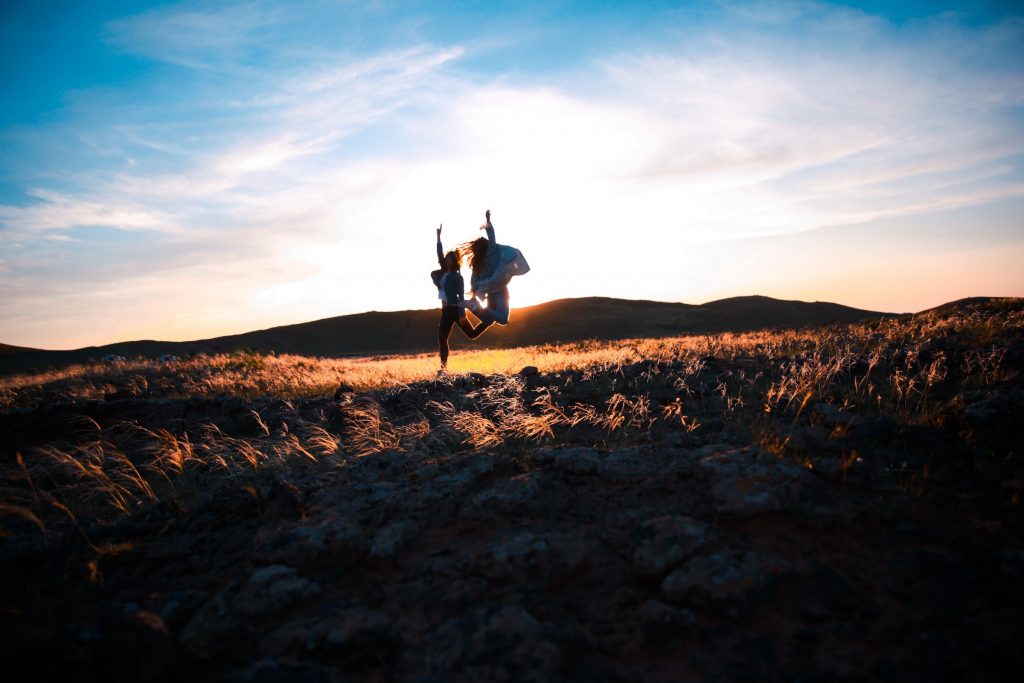 Two people jumping
