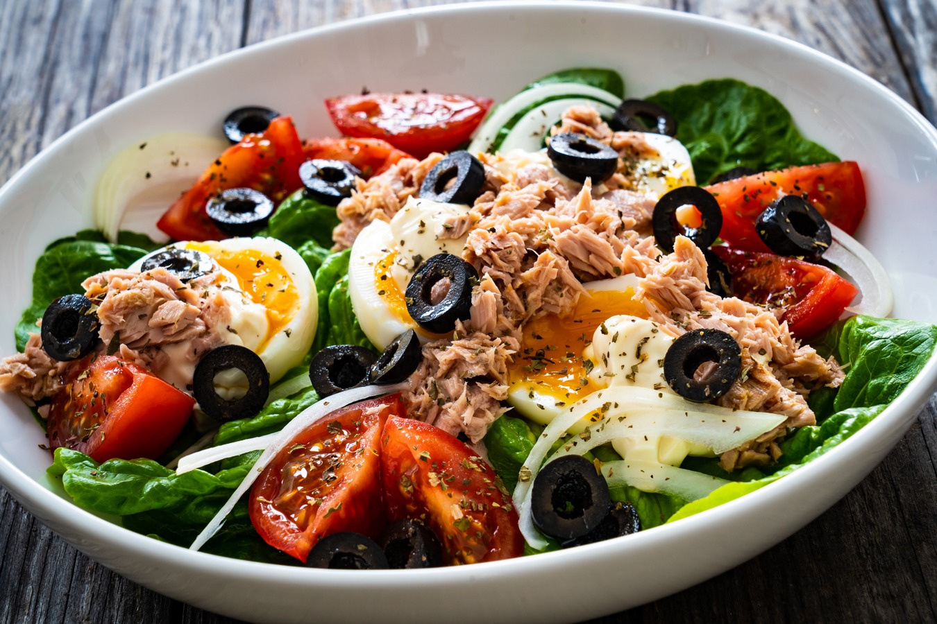 Salade Niçoise: a colorful salad with tuna, hard-boiled eggs, olives and tomatoes, Salade Niçoise: a colorful salad with tuna, hard-boiled eggs, olives, tomatoes, and green beans.
