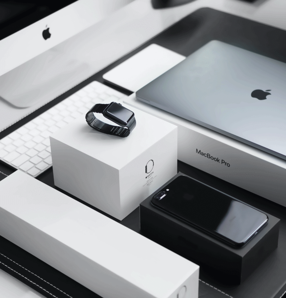 11 graphic design principles to elevate your brand 2 A cinema display, MacBook Pro, Apple Watch, iPhone and keyboard lay neatly arranged on their signature white branded Apple boxes
