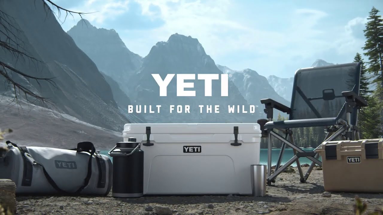 white Yeti cooler at a campsite by a lake